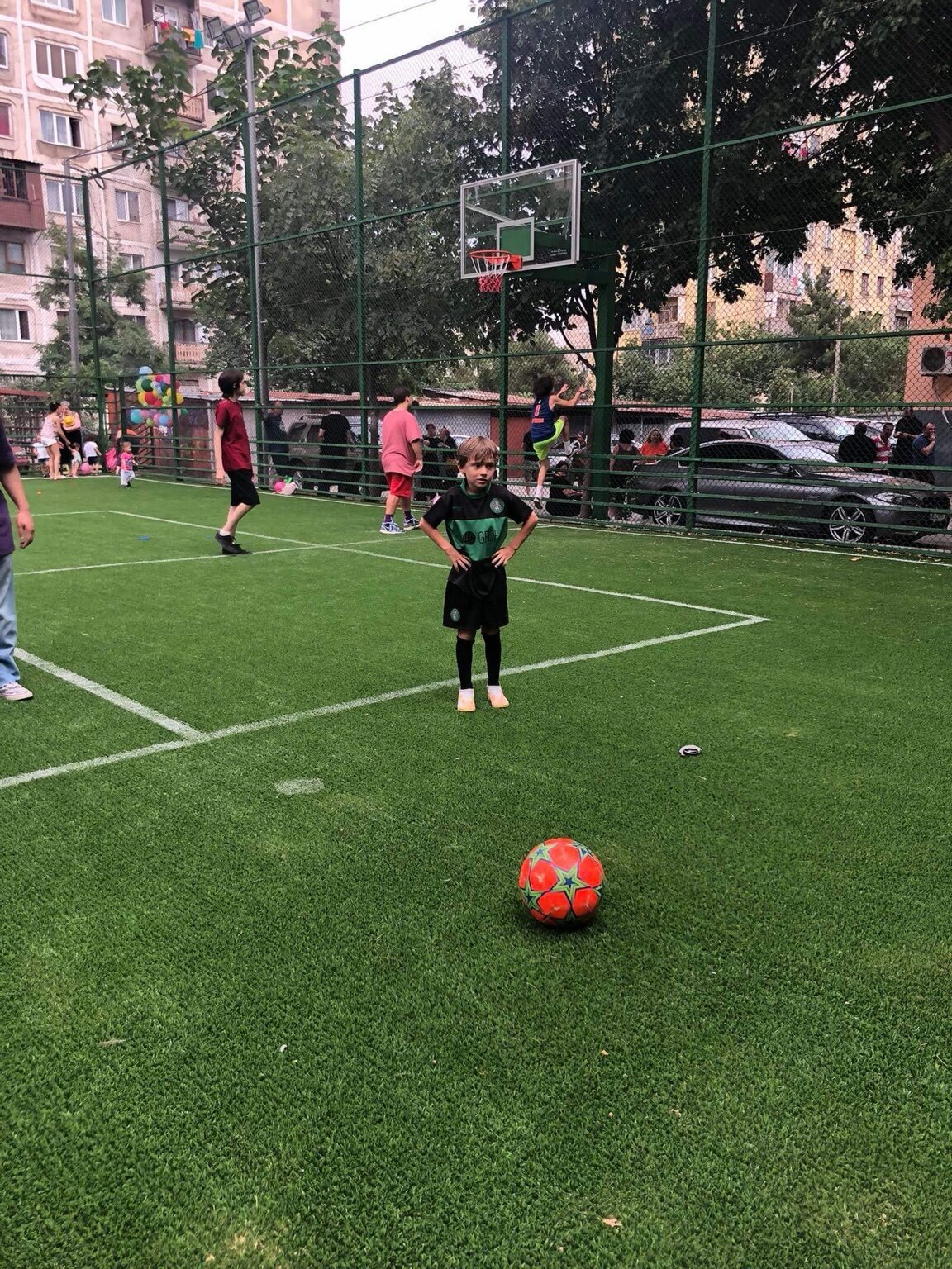 A young Sandro Abesadze standing behind the ball during football practice