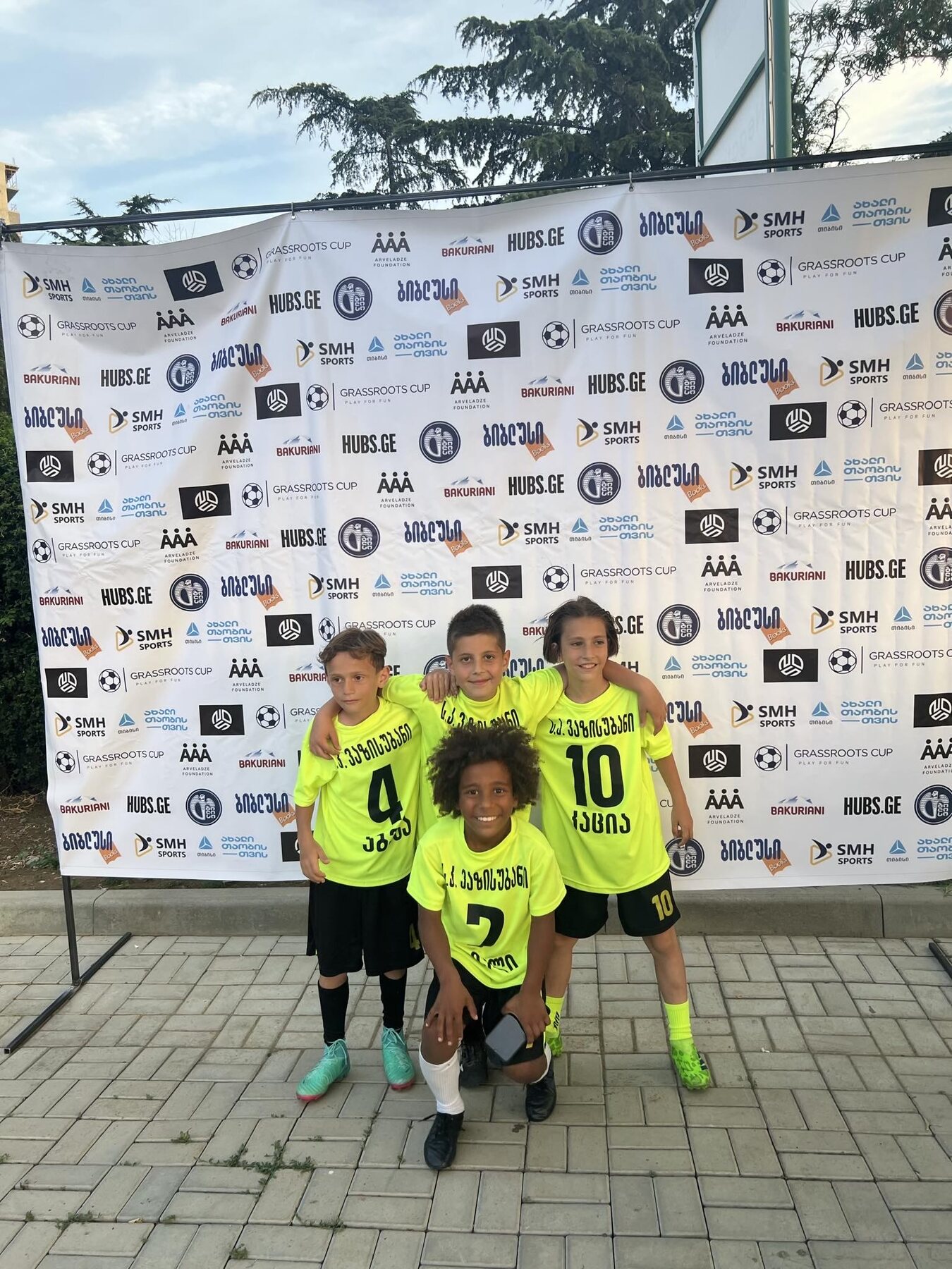 Sandro Abesadze and teammates at the Grassroots Cup photo wall