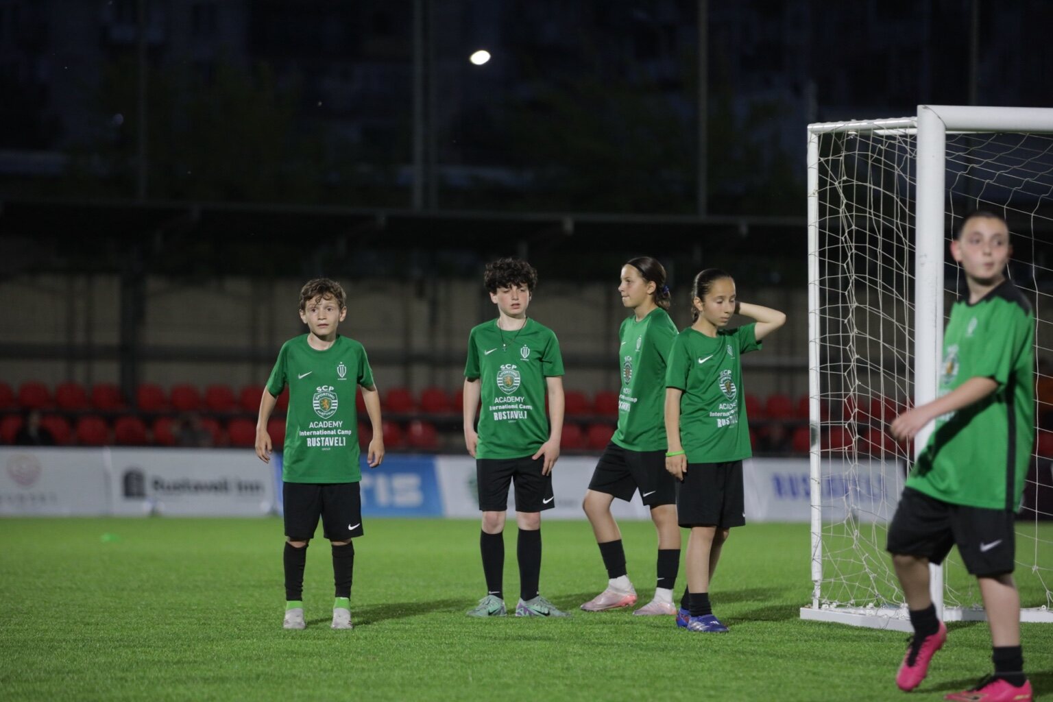 Sandro Abesadze and teammates positioned beside the goal