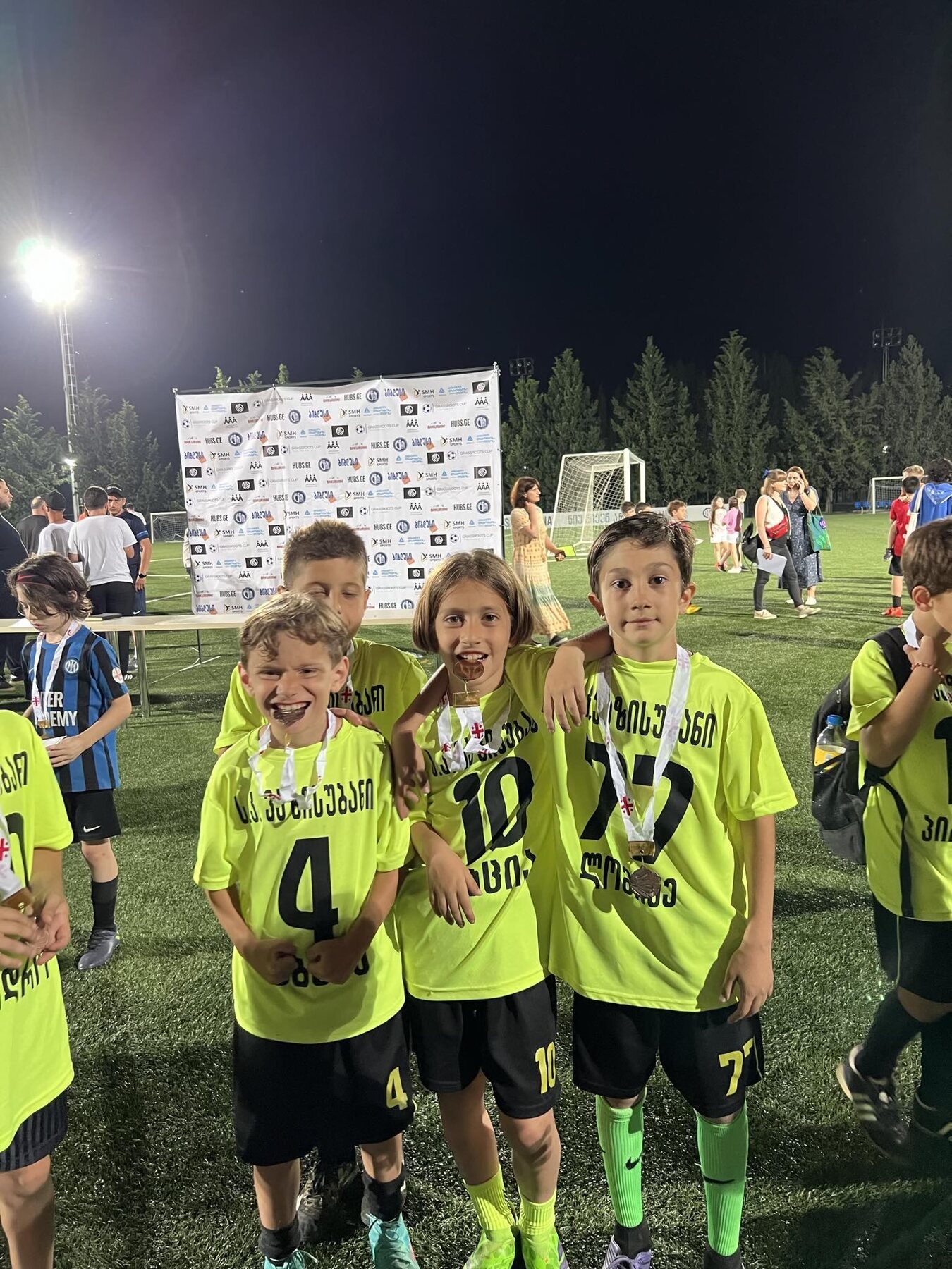 Sandro Abesadze celebrating with teammates and medals